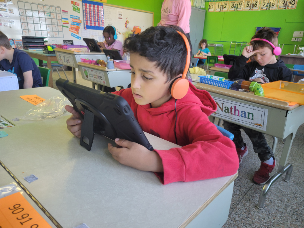 A student reading instruction on iPad